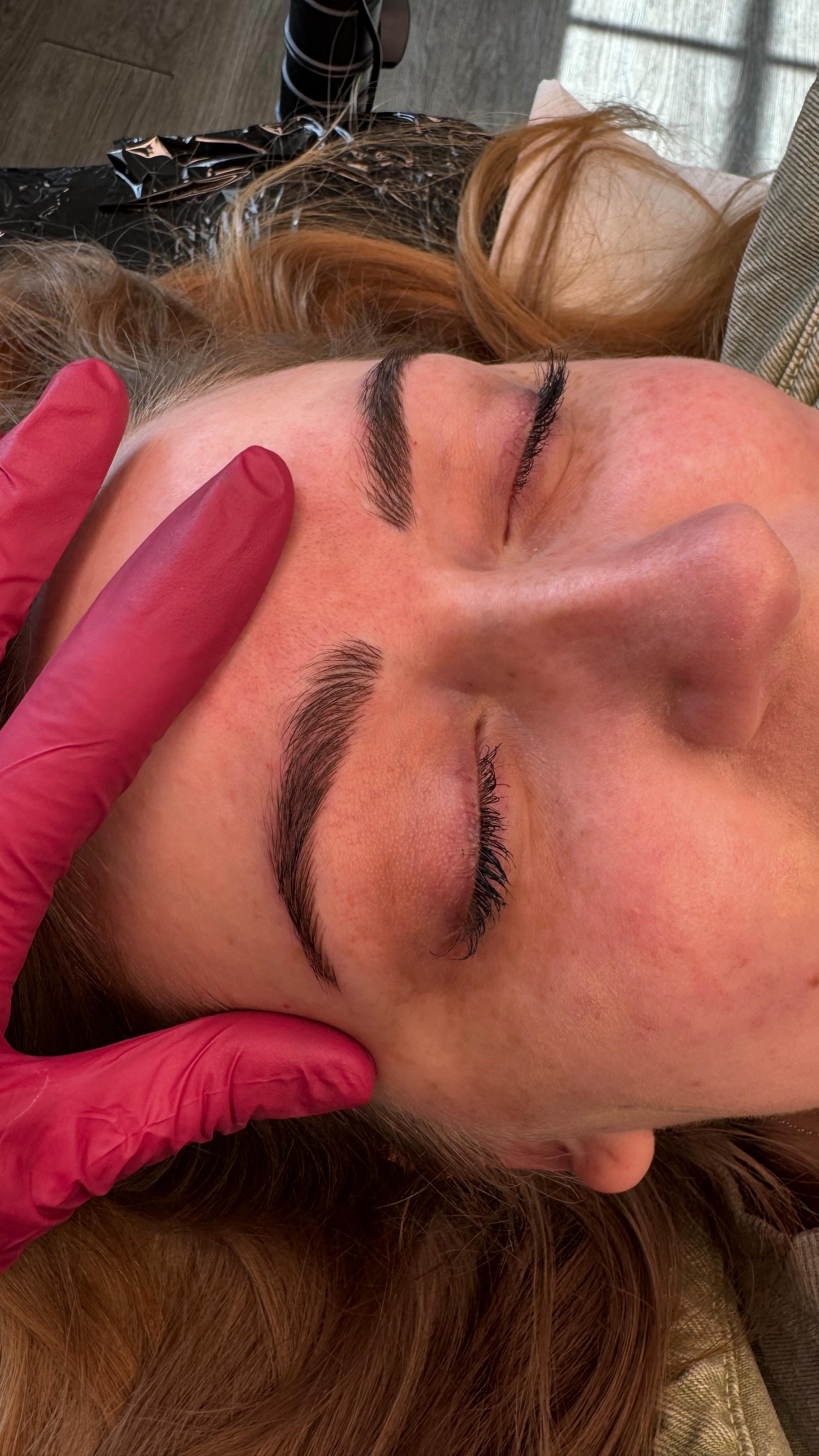 Erin at work on a client's brows